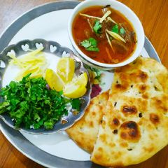 A picture of Beef nihari with kulcha.