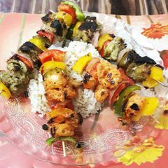 A picture of Chicken and Prawn Kebabs with herbed Rice.