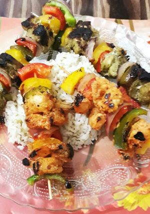 A picture of Chicken and Prawn Kebabs with herbed Rice.