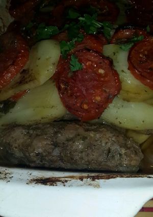 A picture of Baked Kofta with Tomatoes and Potatoes.