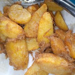 A picture of Fried potatoes in egg.