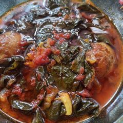 A picture of Haaq te Thool. (collard greens with egg).
