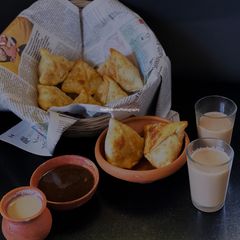 A picture of Bong style Samose with Sweet Sour Chutney and Tea.