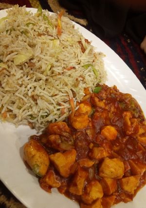 A picture of Chicken Manchurian with fried rice.