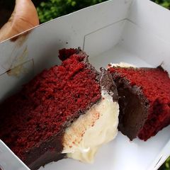 A picture of Red velvet cake frosted with homemade chocolate and cream cheese.