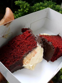 A picture of Red velvet cake frosted with homemade chocolate and cream cheese.