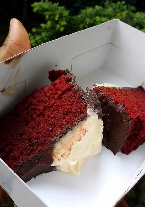 A picture of Red velvet cake frosted with homemade chocolate and cream cheese.