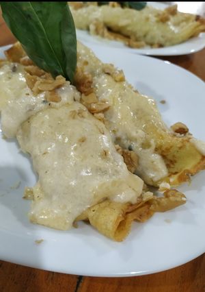 Una foto de Canelones de espinaca con crema de queso y maní