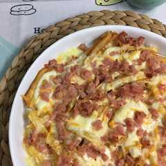 Una foto de Patatas con queso y bacon: patatas Foster´s Hollywood