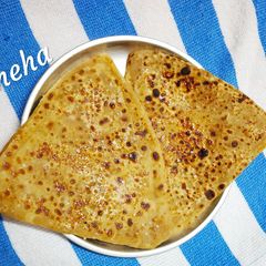 A picture of Sweet Paratha loaded with sugar and milk.