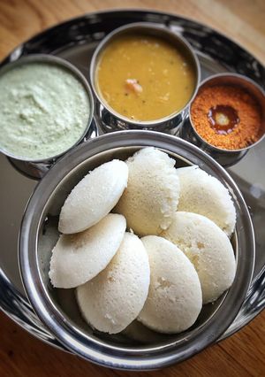 A picture of Fluffy Idli, Chutney,Sambar and idli Podi.
