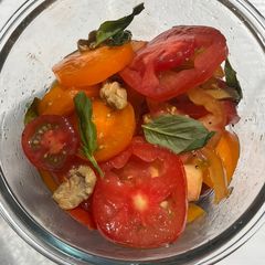 A picture of Isle of Wight/Heirloom/Heritage tomato salad with olives and basil.