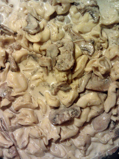 A picture of Tortellini in mushroom and walnut sauce.
