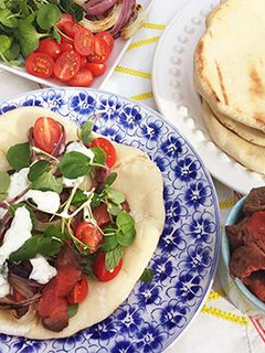 A picture of Fullblood Wagyu Beef Gyros with Tzatziki Sauce.