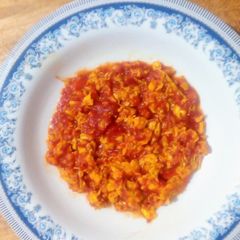 A picture of Scrambled eggs with tomatoes.