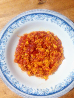 A picture of Scrambled eggs with tomatoes.