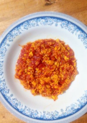 A picture of Scrambled eggs with tomatoes.