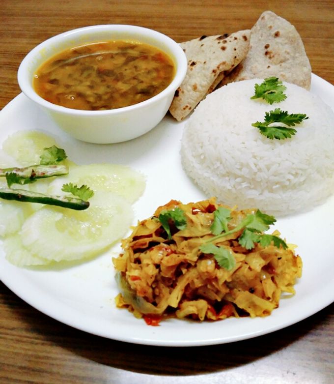 A picture of Healthy dal palak, cabbage sabji,roti,rice and salad.