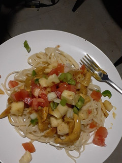 A picture of Spaghetti and chicken strips.