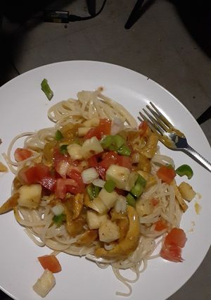 A picture of Spaghetti and chicken strips.