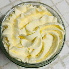 A picture of Milk jelly pudding topped with sweetened whipped cream.