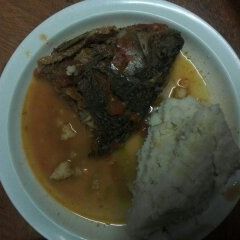 A picture of Fish stew and Ugali.