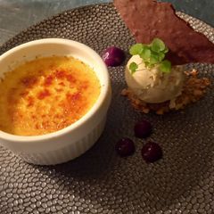 A picture of Caramel Infused Crème Brûlée with Vanilla Ice Cream.