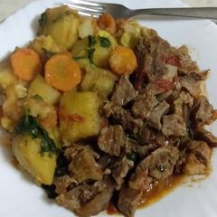 A picture of Beef stew, with matoke.