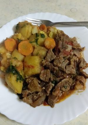 A picture of Beef stew, with matoke.