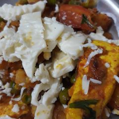 A picture of Matar Paneer with cheese.