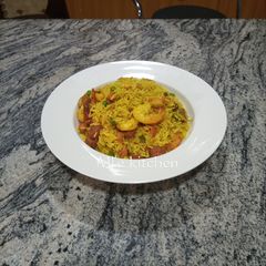 A picture of Fried rice with shrimps and chicken sausage.