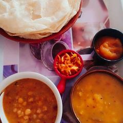 A picture of Halwa, Puri, aloo tarkari & chane ki tarkari.