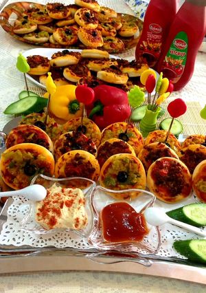 A picture of Mini Pizzas with Various Toppings.