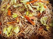 A picture of fried cabbage with carrots and peppers