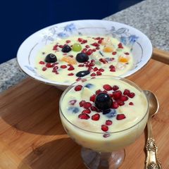 A picture of Fruits in custard sauce.