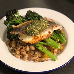 A picture of Pesto seabass with cannellini beans and purple sprouting broccoli.