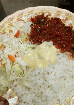 A picture of White rice and stew with cabbage and cream.