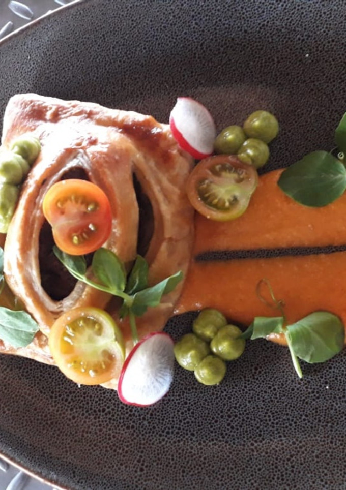 Una foto de Beef Wellington en salsa de cacahuate y rollitos de jamón