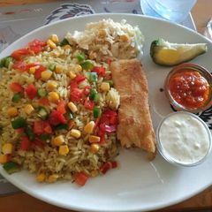 A picture of Garnished rice with coleslaw and omelette.