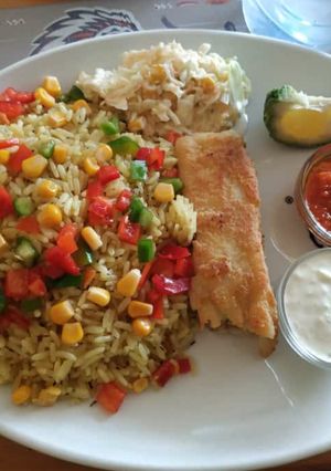 A picture of Garnished rice with coleslaw and omelette.