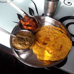 A picture of Saag and makki ki roti.