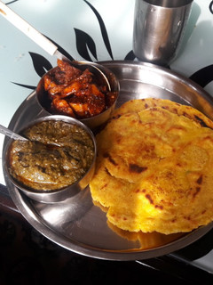 A picture of Saag and makki ki roti.