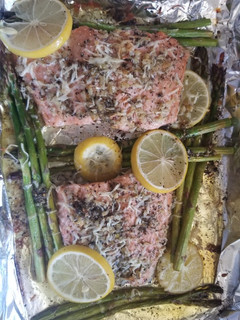 A picture of Baked lemon parmesan salmon Asparagus in foil.