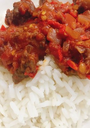 A picture of White rice and tomato sauce with beef.
