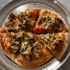 Veg pizza on tawa A picture of Veg pizza on tawa.