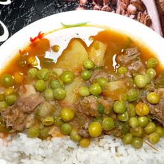 A picture of Beef stew with peas.