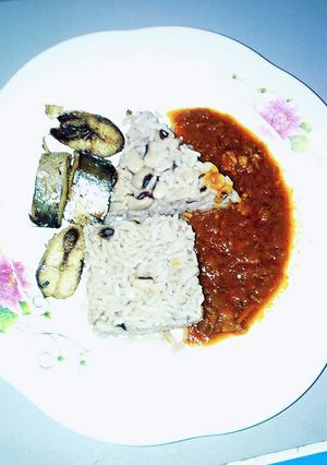 A picture of Rice and beans with stew.