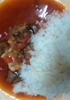 A picture of Beef stew served with Rice.