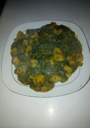 A picture of Yam porriage with ugu and uziza leaves.