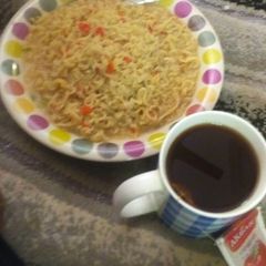 A picture of Noodles and black tea.